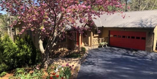 Christmas Cottage home exterior and driveway, cherry blossom tree.